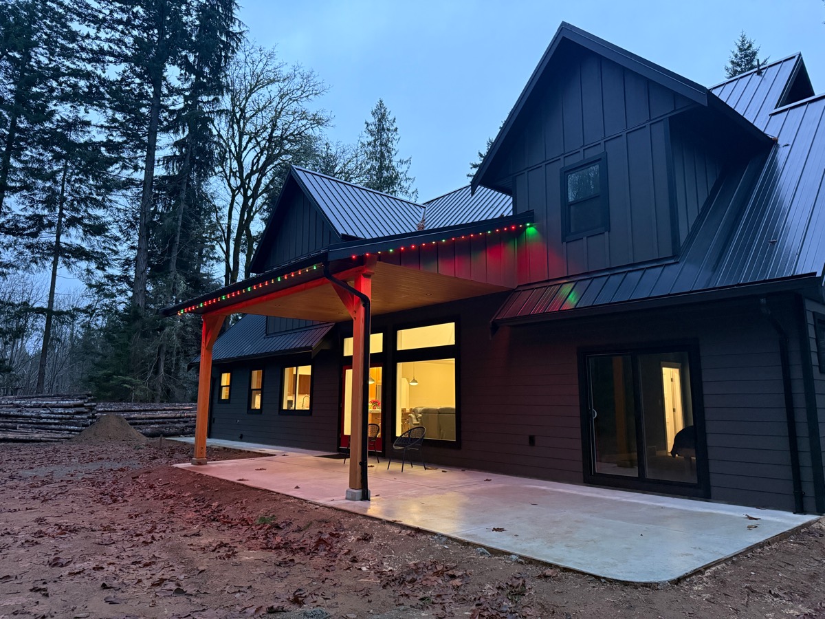 Gemstone Lights in red and green along the back patio roofline of a new home.