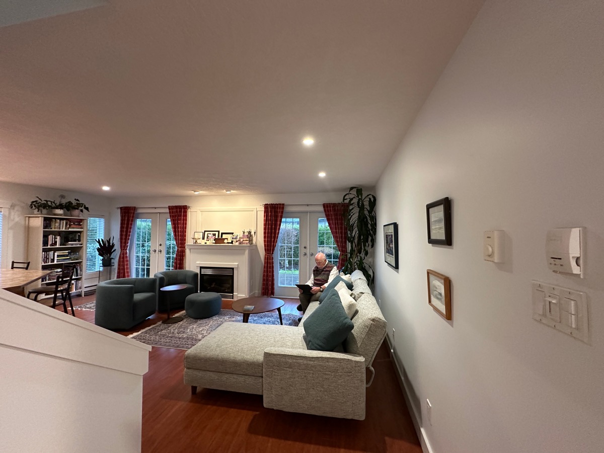 Pot lights in a finished living room with a gas fireplace and French doors.
